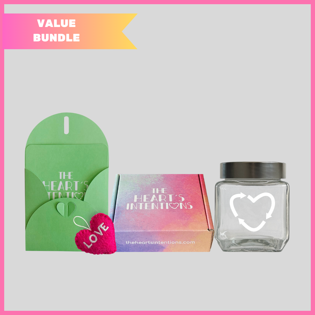 A card and envelope set with a charming heart closure alongside a heart with the word Love on it, beautifully presented next to a heart holder jar with a lid on it to hold your hearts and a The Heart's Intentions gift box, a meaningful way to create lasting memories through a thoughtful gift.