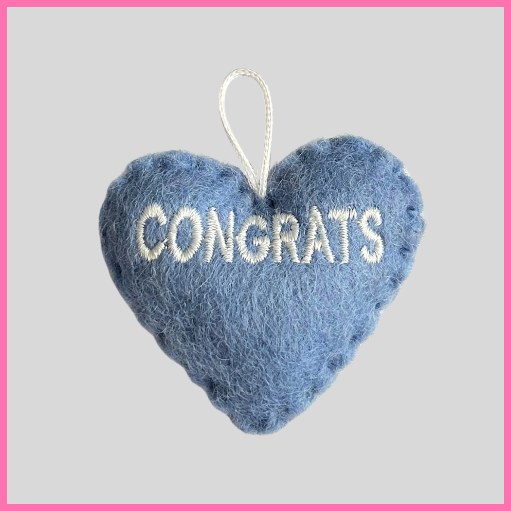 A light blue Congrats Heart with the word CONGRATS on it, an ideal gift for celebrating birthdays, anniversaries, graduations, baby showers, or any special occasion. Perfect for sharing a graduation message like “Congrats! Let your heart be your guide on your next adventure!”