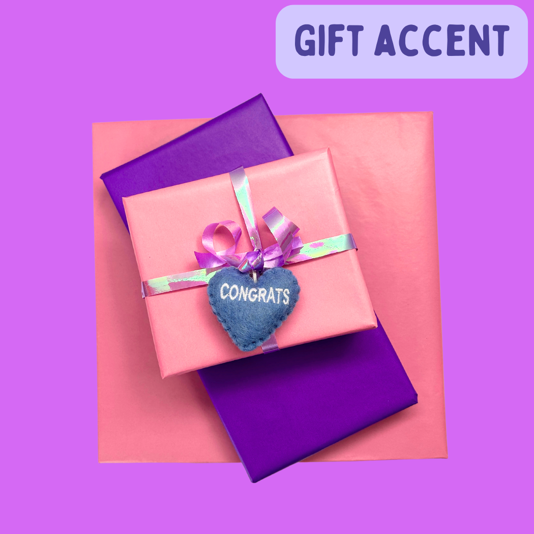 Wrapped gifts with a Congrats Heart attached to the ribbon.