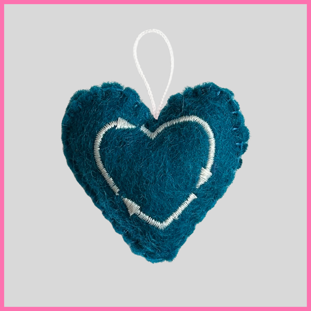 Back of a teal Gratitude Heart showing The Heart's Intentions heart logo.