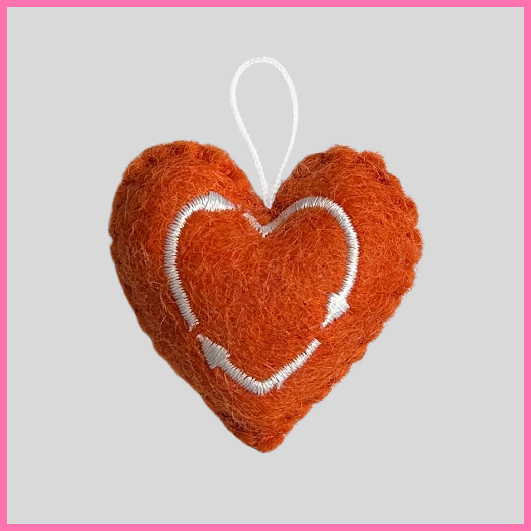 Back of an orange Happiness Heart showing The Heart's Intentions heart logo.