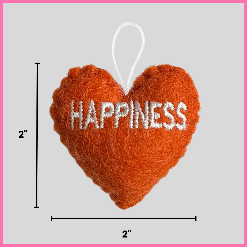 An orange Happiness Heart showing its dimensions, two inches by two inches.