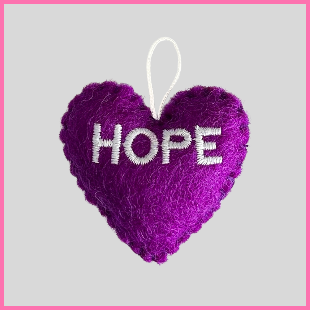 A purple felt Hope Heart with the word HOPE on it, a heartfelt gift to send uplifting sentiments and inspire hope. Perfect for connecting with a loved one in a time of need, with a message like “Keep hope in your heart because tomorrow is a new day!”