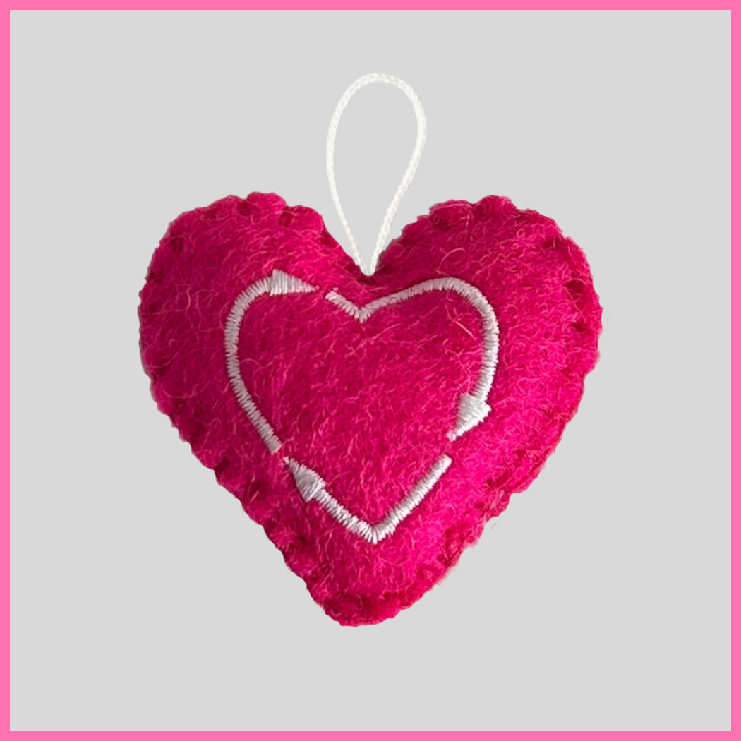 Back of a vibrant pink Love Heart showing The Heart's Intentions heart logo.