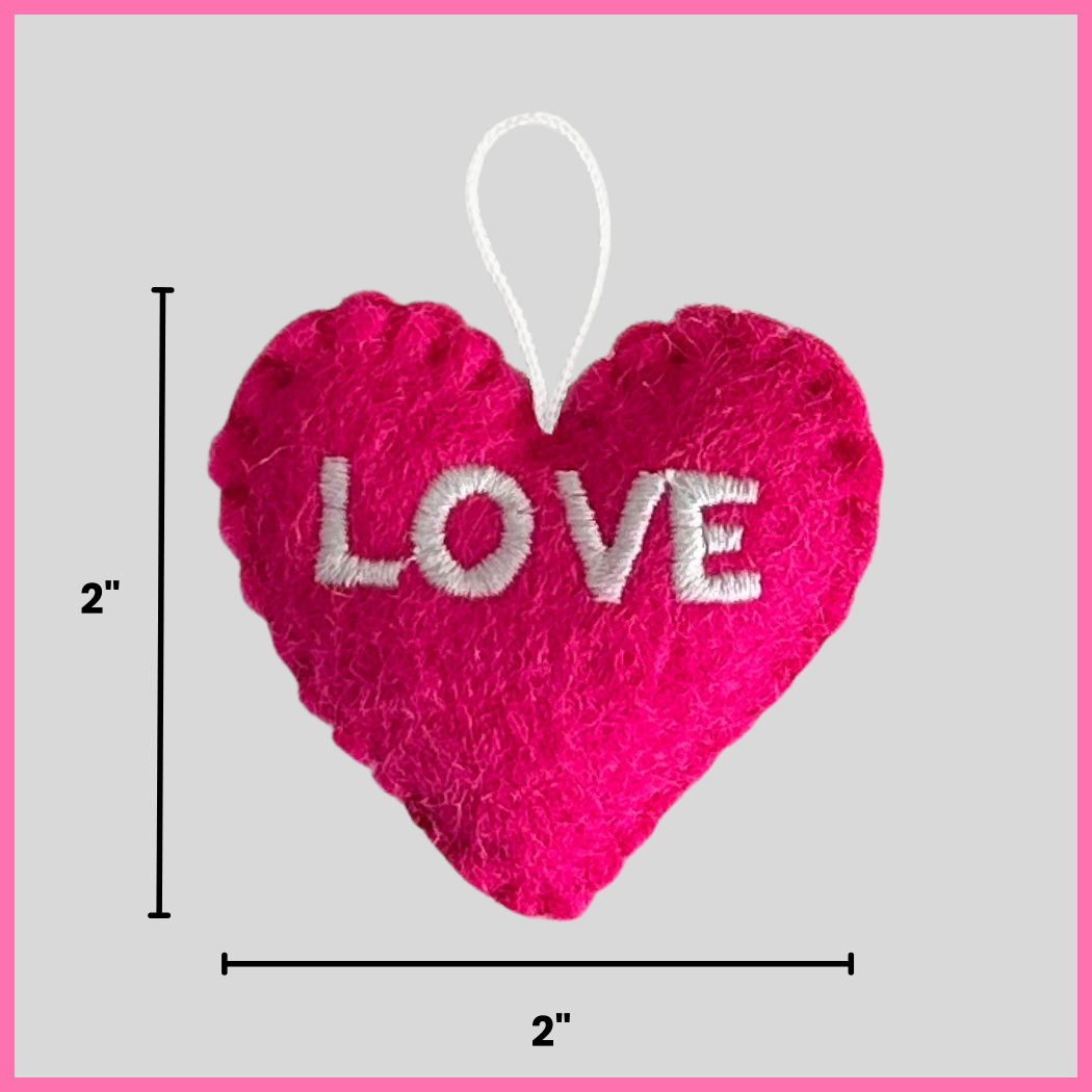 A vibrant pink Love Heart showing its dimensions, two inches by two inches.