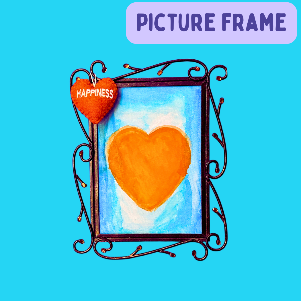 Picture frame with an orange heart painting in it and a Happiness Heart hanging on it.