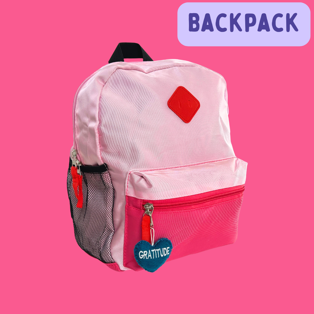 Pink backpack with Gratitude Heart hanging on the zipper.